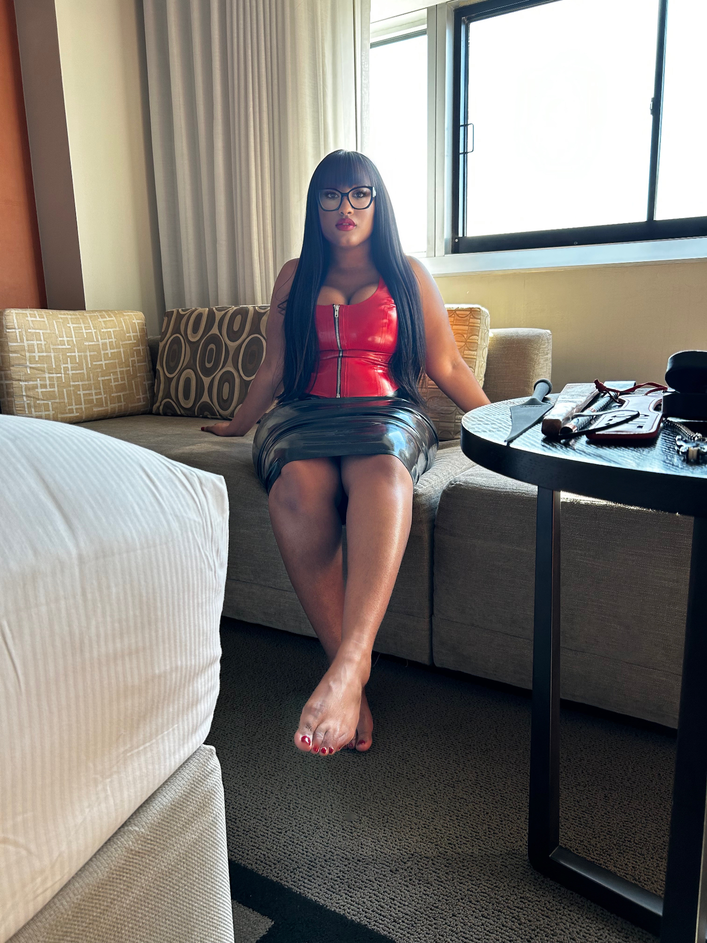 Mistress Tonee in red latex corset — hotel suite